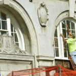 worker on Hotel Morgan exterior